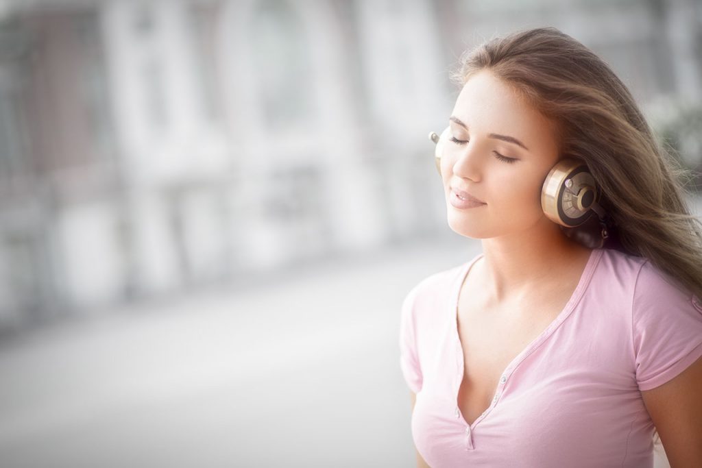 Girl listening to 8D Music with headphones