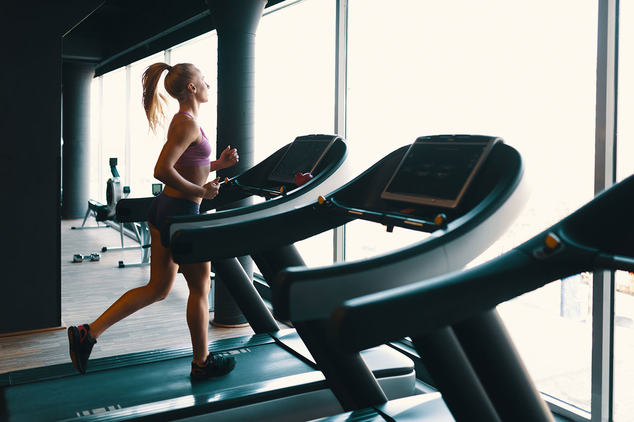 Blonde Woman Running on Treadmill